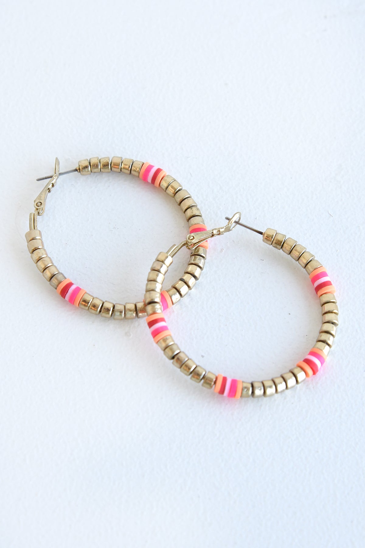 PINK AND GOLD DISK HOOPS